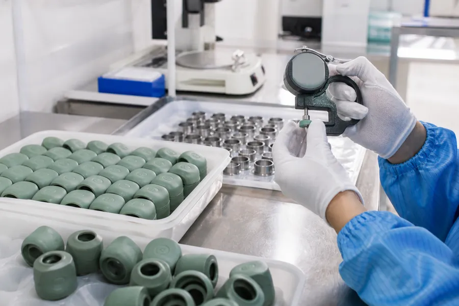 Technician inspecting incoming production materials